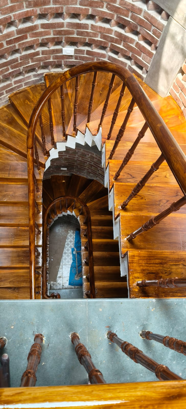Top view through the completed curved timber staircase and polished handrail