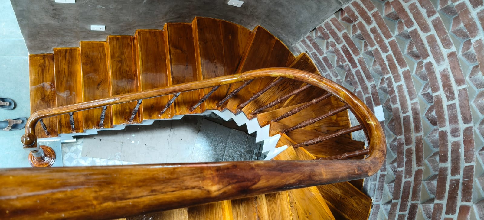 Sweeping curved handrail and timber treads viewed from above