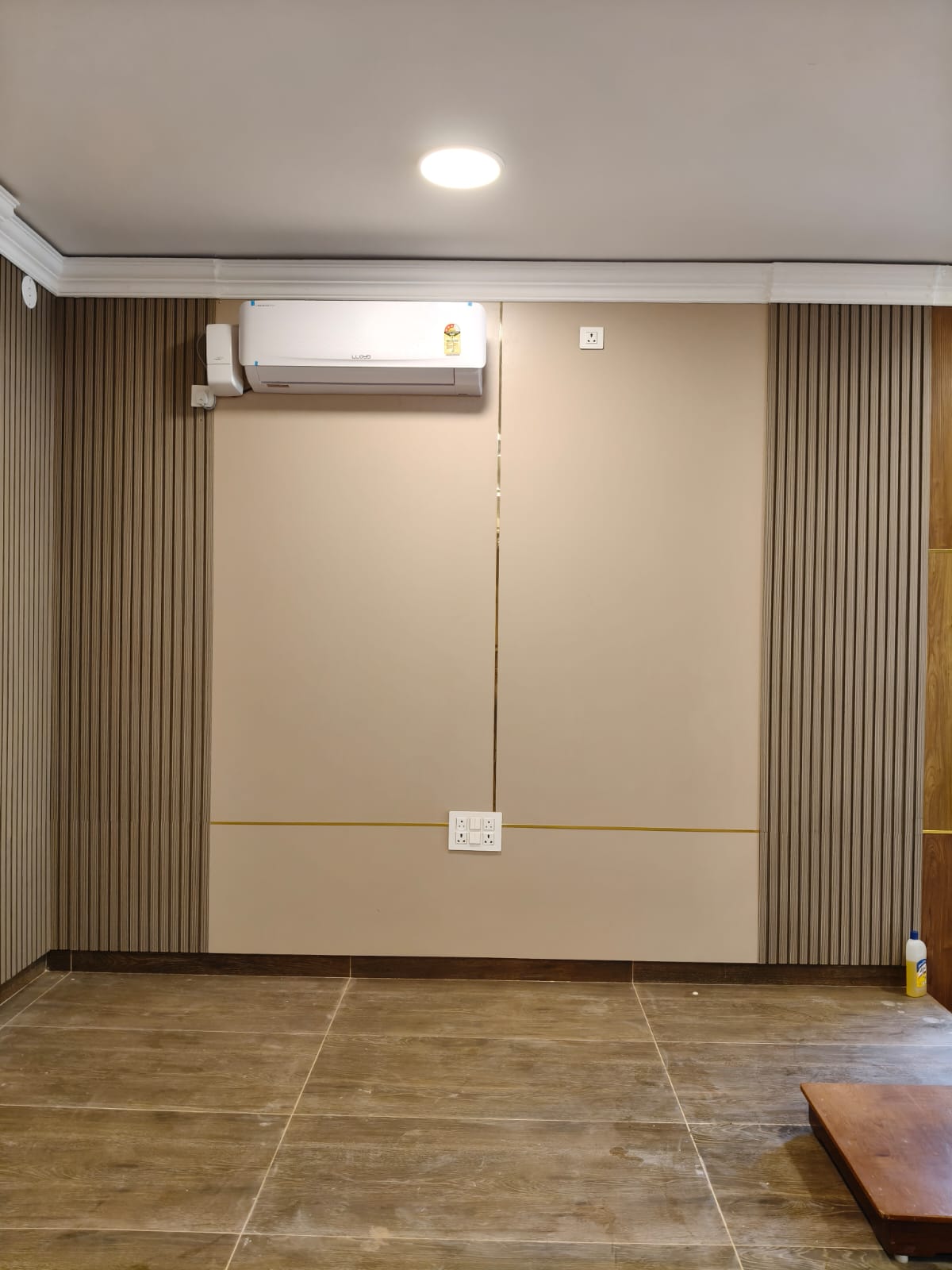 Fluted wall panel and inset detail beneath an air-conditioning unit
