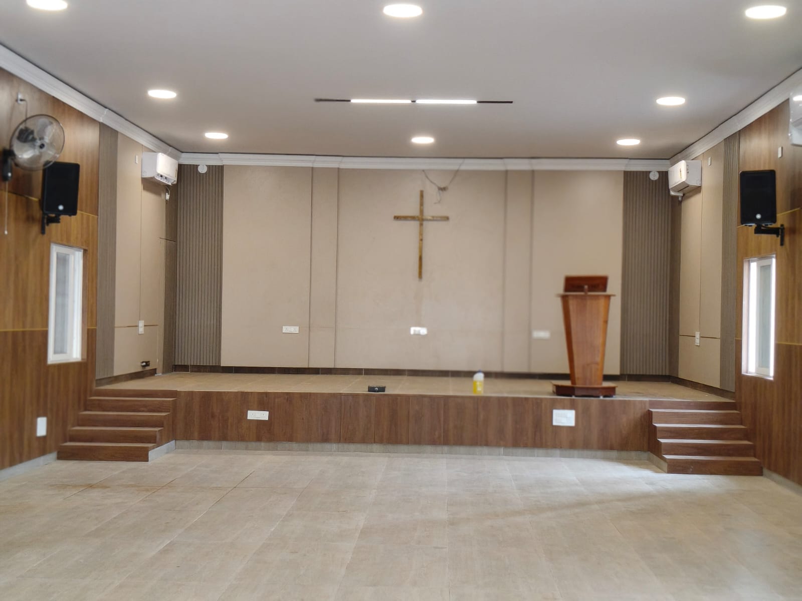 Completed raised church platform with timber steps, lectern, and cross
